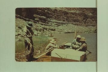 Frost party in the Goosenecks of the San Juan.Left to right: Walter Pelzner; Glennon Robinson (boatman); Robert A. Uihlein (sitting in stern, VP of Schlitz Brewing Co.); Owen Gromme (Curator of Milwaukee Public Museum)