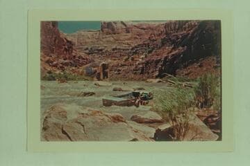 Lining one of the Frost punts on the San Juan River- Skipper Frank E. Frost in front, William A. Rowan and Arch H. Rowan, Jr. Syncline Rapid in high water