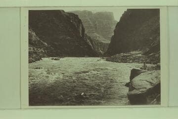 Identified by Emery Kolb as Lauzon on shore below Supai. The extreme low water the Kolbs experienced in 1911-1912 gave them a difficult rocky course with relatively slow water