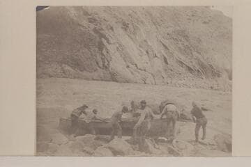 Portage by Stanton crew: "Lifting a Boat over the Head of a Rapid. Grand Canon."