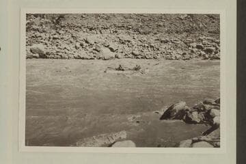 One of the large four-oared boats of the Eddy fleet running a rapid in upper Cataract Canyon. Copied from Carey collection