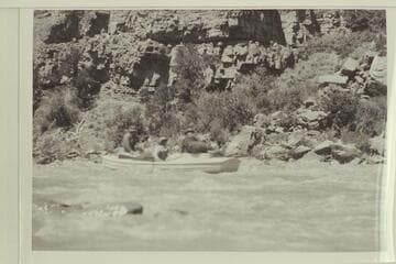 Loper at the oars in a small rapid in Red Canyon. Trimble and Woolley are riding with him