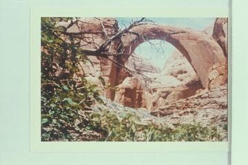 Inscription: "The Worlds Greatest Natural Bridge, 309 ft. high, 277 ft. span, Discovered and Surveyed Aug. 14, 1909" on rock at foot of Rainbow Bridge
