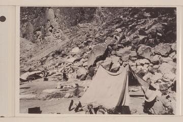 Eddy's boat "Powell" rolled on shore. She capsized when being lined in Cataract Canyon at the head of The Big Drop. Note food and clothing out to dry. From Carey collection