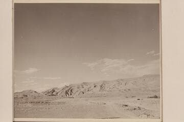 Raplee Anticline at Mexican Hat on the San Juan River. Nevills home at right. One of the Nevills boats is on the trailer back of the car