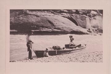 Skiff of Lasky party in small rapid just below Hite. Jesse Lasky, Jr., and Kenneth Wortley