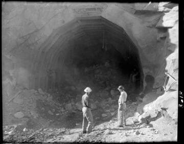 Construction work at mouth of Big Creek 4's powertunnel. Hayes and friend are by dusty tunnel mouth with rubble