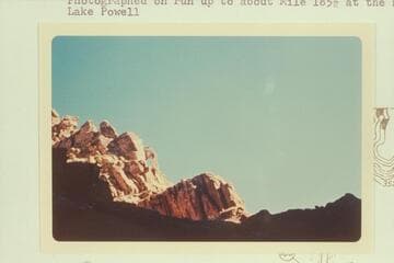 Small arch on skyline, Narrow or Cataract Canyon. Photographed on run up to about Mile 185.5 at head of Lake Powell