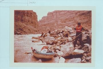 Dock Marston lining a Sportyak thru Dark Canyon Rapid. Jorgen Visbak and Buzz Belknap in distance
