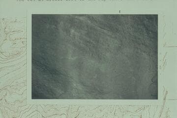 John F. Hoffman's effort to photograph a D. Julien inscription on the east side of a boulder at Mile 212 1/2, left bank, 1/4 mile from the river and 600 ft. above it. Discovery is credited to Mark Lindquist of Portland