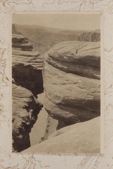 Down from the rim to the Colorado River in Cataract Canyon at approximately Mile 215. Looking down 1200' to Colorado through crack in canyon wall near junction of Grand and Green to form the Colorado