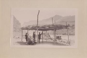 Zahn party under shelter at Lees Ferry. The Zahn car in the background